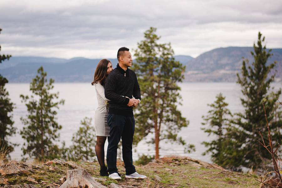 Man and woman standing on a cliff looking out