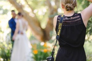 kelowna photographer, Kristine taking a photo of a bride and groom