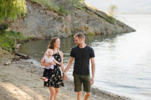family portrait of mom and dad walking with baby