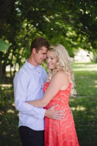 couple smiling, leaning into each other