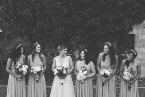bride and brides maids celebrating with smiles