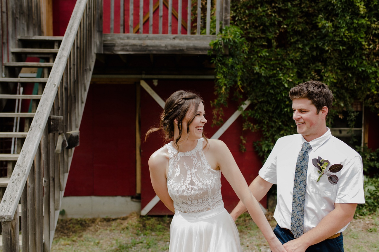 Bride and groom in front of a barn at Sproule's Farm, Lake Country