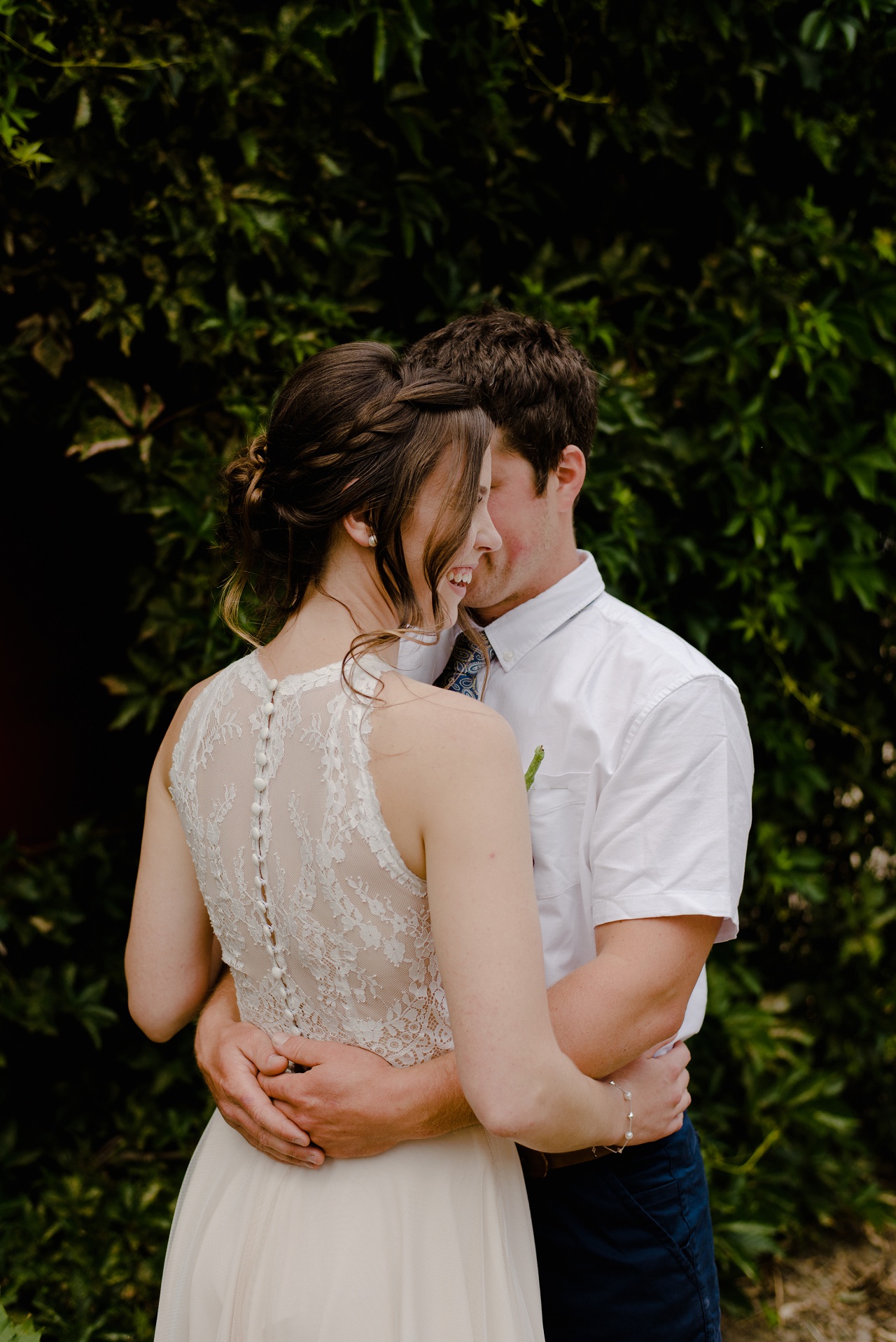 Bride and groom in front of a barn at Sproule's Farm, Lake Country